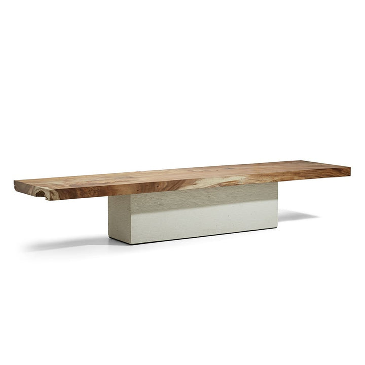 A modern minimalist bench featuring a thick slab of natural wood as the seat supported by a solid rectangular beige base.