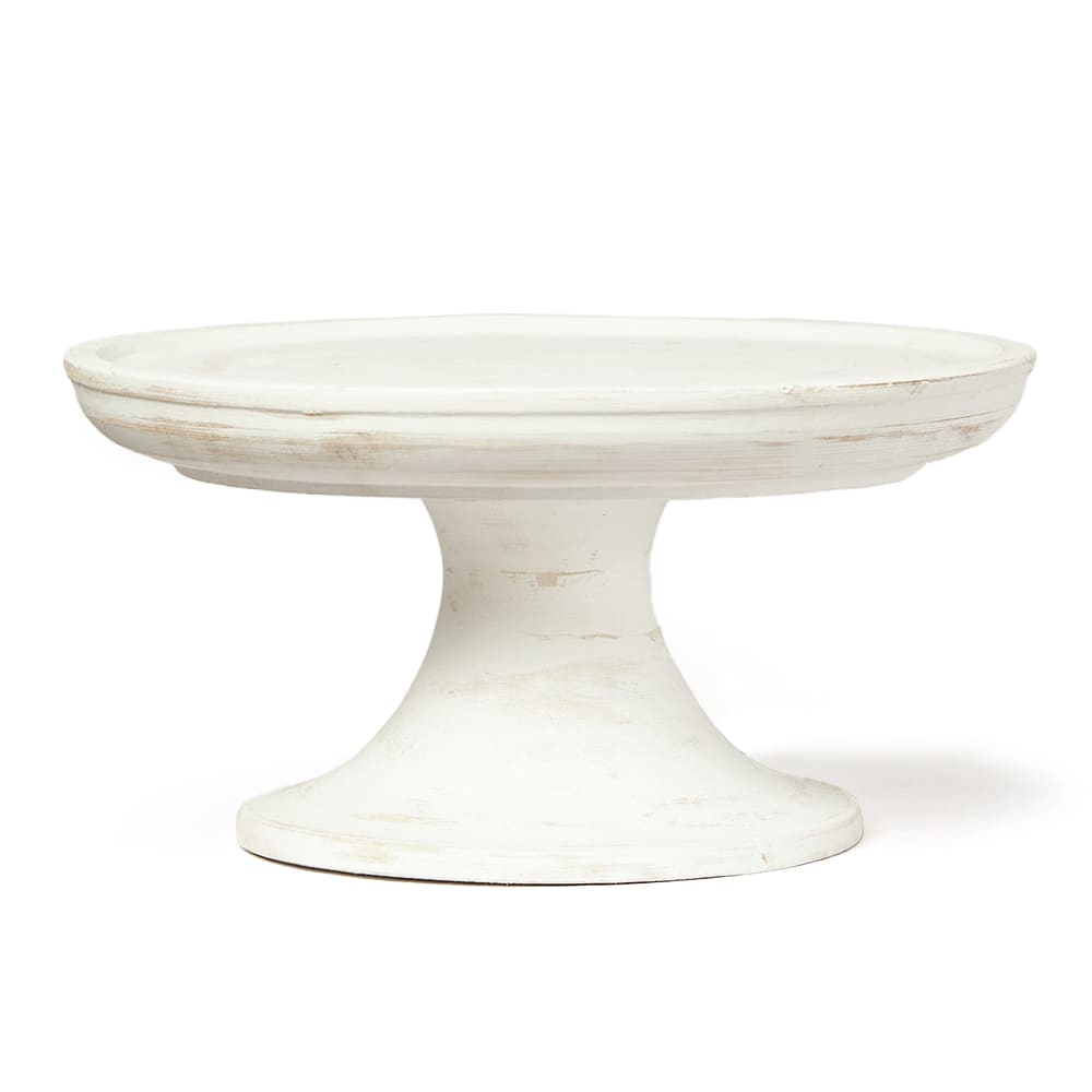Base de torta de cerámica o madera pintada de blanco con acabado envejecido, de forma circular y con pedestal ancho. No se observan inscripciones ni marcas visibles en el producto.