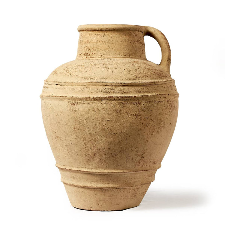Una vasija de cerámica grande de color beige con un acabado rugoso y mate. Tiene forma clásica con una sola asa en la parte superior y líneas ornamentales horizontales alrededor de su cuerpo.